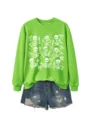 Details view of women Halloween crewneck sweatshirt featuring cute skeleton and bow prints. - S / Tops / Neon Green Sweatshirt (White Pattern)
