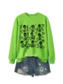 Detailed view of the bright green Halloween skeleton graphic sweatshirt paired with blue denim shorts. - S / Tops / Neon Green Sweatshirt (Black Pattern)
