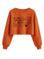 Orange cropped sweatshirt detail featuring cute black outline cats in boxes and pockets. - Burnt Orange