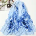 Close-up detail of light blue chiffon floral scarf featuring elegant blue botanical print. - Peony Sky Blue