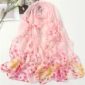 Detailed view of the pink chiffon floral scarf, elegant branch print texture and soft fabric. - New Year Flower Snow Bud