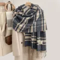 Detailed view of cozy imitation cashmere plaid scarf with fringe, soft winter accessory. - Black