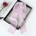 Closeup detail of the elegant light pink solid color long ribbon silk scarf for women styling. - Light Purple