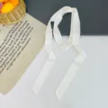 Solid white narrow satin silk scarf detail showing smooth texture and ribbon design. - White