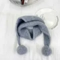 Detail view of grey knitted kids neck warmer with cute pom-poms, soft winter scarf close-up. - Light Gray