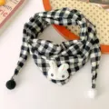 Close-up detail of black and white plaid baby scarf with cute rabbit doll and pom-pom ends - Black White Rabbit Plaid Triangle Scarf