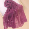 Close-up detail of the purple sequin gauze scarf texture, sparkling design for autumn style. - Violet