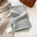 Grey knitted scarf detail, soft and warm winter accessory flat lay with clothing and bag prop. - Light Gray
