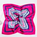 Close-up detail of the pink and blue geometric striped square professional silk scarf. - Rose Edge Navy