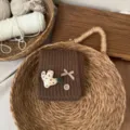 Kids brown knitted neck warmer detail, cute cactus patch and plaid bow design for winter warmth. - Coffee