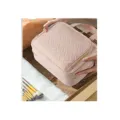 Detail view of pink quilted large capacity women toiletry bag with handle and zipper compartments - Pink