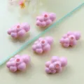 Close-up detail of cute pink acrylic cloud beads for DIY jewelry making accessories. - 3D Style / Pink