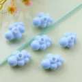Close-up view of light blue acrylic 3D cloud beads with holes, perfect for DIY jewelry crafting. - 3D Style / Light Blue