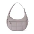 Detail view of the quilted puffer shoulder bag with adjustable strap and soft crescent shape. - Camel