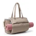 Detail shot of beige quilted puffer tote bag with yoga mat holder and spacious design. - Camel