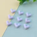 Detail shot of light purple heart beads, smooth resin surface, perfect for DIY jewelry crafting. - Purple Blue Plaid