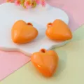 Detailed view of 27mm orange glossy heart pendant charms for DIY jewelry and keychain making. - 27mm Orange