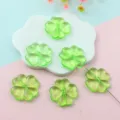 Green four-leaf clover acrylic beads detail shot showing transparent texture and hole for jewelry. - 25mm / Transparent Green