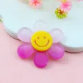Primo piano dettagliato del ciondolo di fiore in acrilico rosa con simpatica faccia smiley. - Stile Rosso Rosa Sfumato da 3 cm