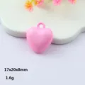 Close-up view of pink acrylic heart pendant, smooth glossy finish with a practical hanging hole. - Pink