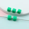 Close-up detail of green acrylic faceted square beads, perfect for DIY jewelry making and spacer design. - Style B Green 8mm