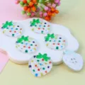 Detailed view of colorful acrylic strawberry shaped 4-hole buttons for DIY crafts and accessories. - Colorful Dots