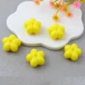 Close-up of 18mm acrylic yellow plum blossom beads, perfect for DIY jewelry and phone chains. - Yellow