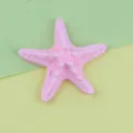 Close-up view of a cute pink resin starfish accessory, showing detailed texture for DIY crafts. - 53mm / Pink