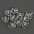 Close-up of clear acrylic heart beads with cute tulip print for handmade jewelry crafting. - Flower 6