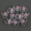 Detail view of 15mm clear acrylic heart beads with pink flower print for DIY craft accessories. - Flower 7