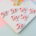 Pink acrylic bow pendants with holes, cute ribbon charms for DIY jewelry making and crafts. - 16mm / Light Pink