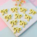 Yellow acrylic hollow bow knot pendant charm for jewelry making, DIY craft accessory detail view. - 16mm / Light Yellow