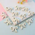 White ribbon bowknot pendant charms with hanging hole, hollow DIY jewelry accessories for crafting. - 16mm / White