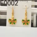 Close-up detail of Christmas candle and holly leaf drop earrings, alloy with red and green rhinestones. - Candle Holly Style(E0002) / Gold