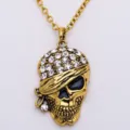 Vintage gold tone skull pendant necklace with sparkling rhinestones, punk style Halloween jewelry. - Antique Gold
