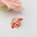 Close-up of a cute rhinestone red enamel bee brooch, stylish insect lapel pin accessory. - Red Bee
