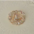 Elegant gold-tone crystal rhinestone swirl brooch pin fashion women jewelry accessory. - White