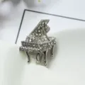 Exquisite rhinestone piano brooch, silver-tone alloy musical instrument lapel pin for women. - Bright White K