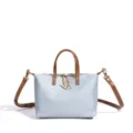 Light blue canvas handbag with brown leather handles, stylish casual women's crossbody bag. - Light Blue