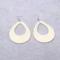 Close-up of large cream teardrop hollow earrings showcasing smooth acrylic surface and hook design. - Beige Waterdrop