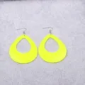 Close-up detail of neon yellow hollow teardrop acrylic earrings with metal hooks. - Yellow Pear
