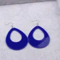 Close-up detail of large blue teardrop hollow acrylic earrings with silver hooks on tray. - Blue Water Drop