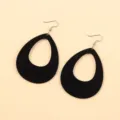 Close-up detail of black acrylic teardrop hollow earrings, showing sleek minimalist design. - Black Waterdrop