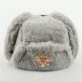 Grey faux fur ushanka winter hat with metal badge, warm earflap trooper bomber cap for outdoor. - One Size / Light Gray + Double-Headed Eagle Badge