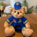 Plush teddy bear toy in blue firefighter uniform with badge and hat detail shot. - Blue Firefighter Bear / 25cm