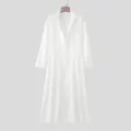 White men's long coat detail view showing the elegant standing lapel and A-line swing design. - S / White