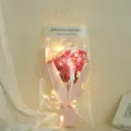 Romantic pink dried baby's breath bouquet inside clear gift bag featuring warm LED lights. - European Style Pink Gypsophila with LED and Gift Bag