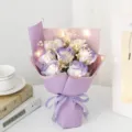 Valentine's Day soap rose bouquet with baby's breath, fairy lights, and purple gift wrap. - 7 Roses With Lights / Lilac Purple
