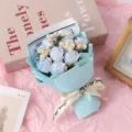 Detail view of a 9-head blue soap rose mini dried flower bouquet with elegant wrapping paper. - Ice Blue