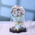 Detail view of preserved rose bouquet inside a clear glass dome with warm LED fairy lights. - 9 Roses Glass Cover with LED Lights and Handbag / Ice Blue